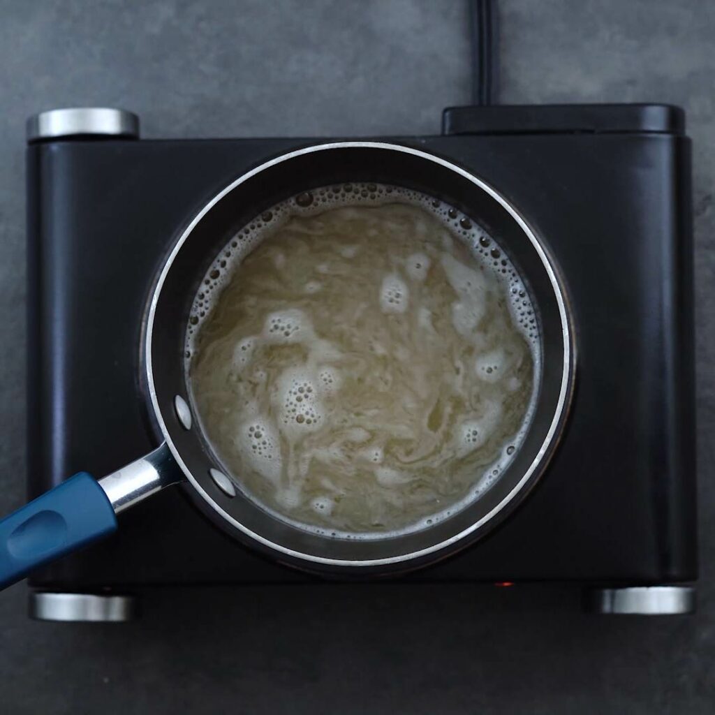 Boiling sugar syrup in the sauce pan.