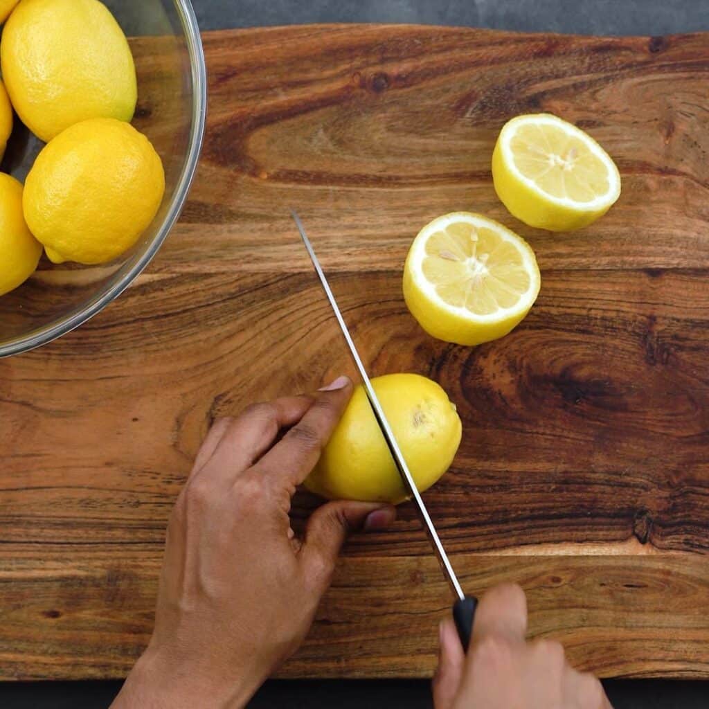Cutting lemons in half.