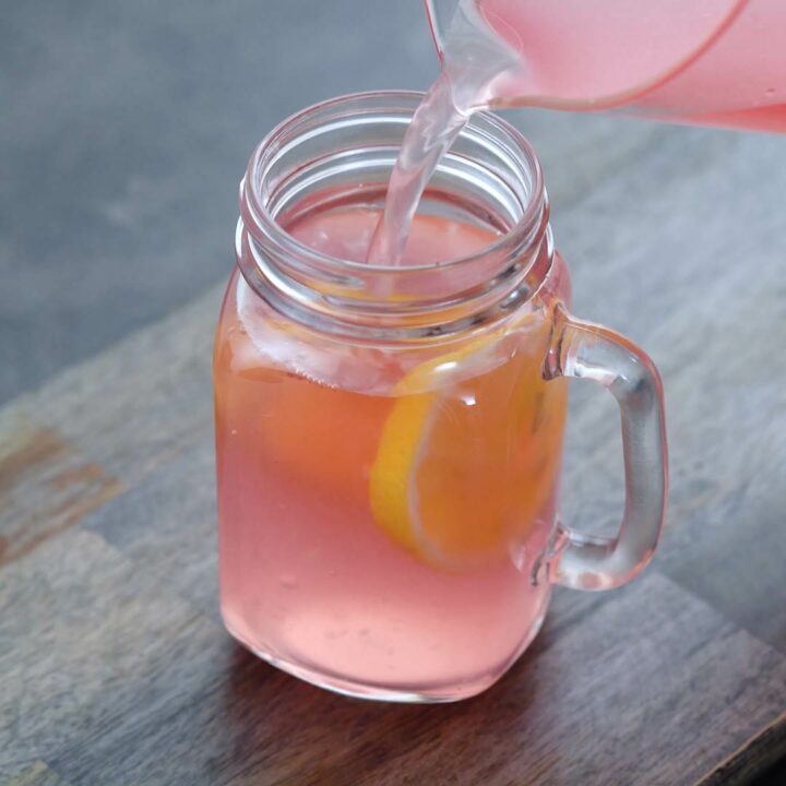 Pouring Pink Lemonade into a serving glass.