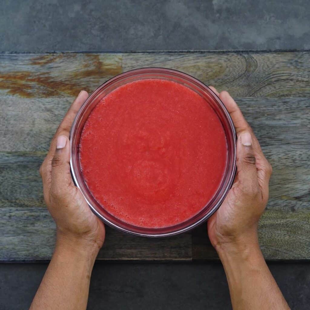 Strawberry puree in a glass bowl.