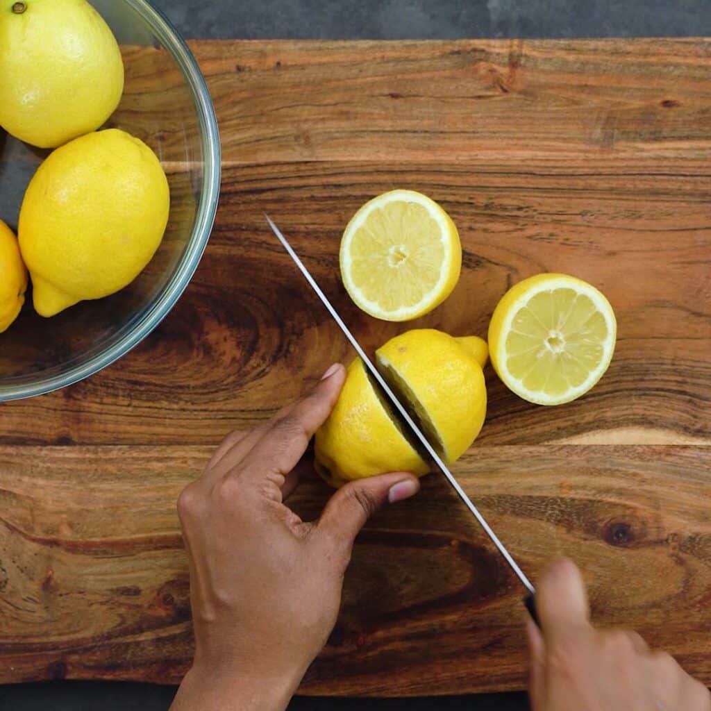 Cutting the lemons in half.