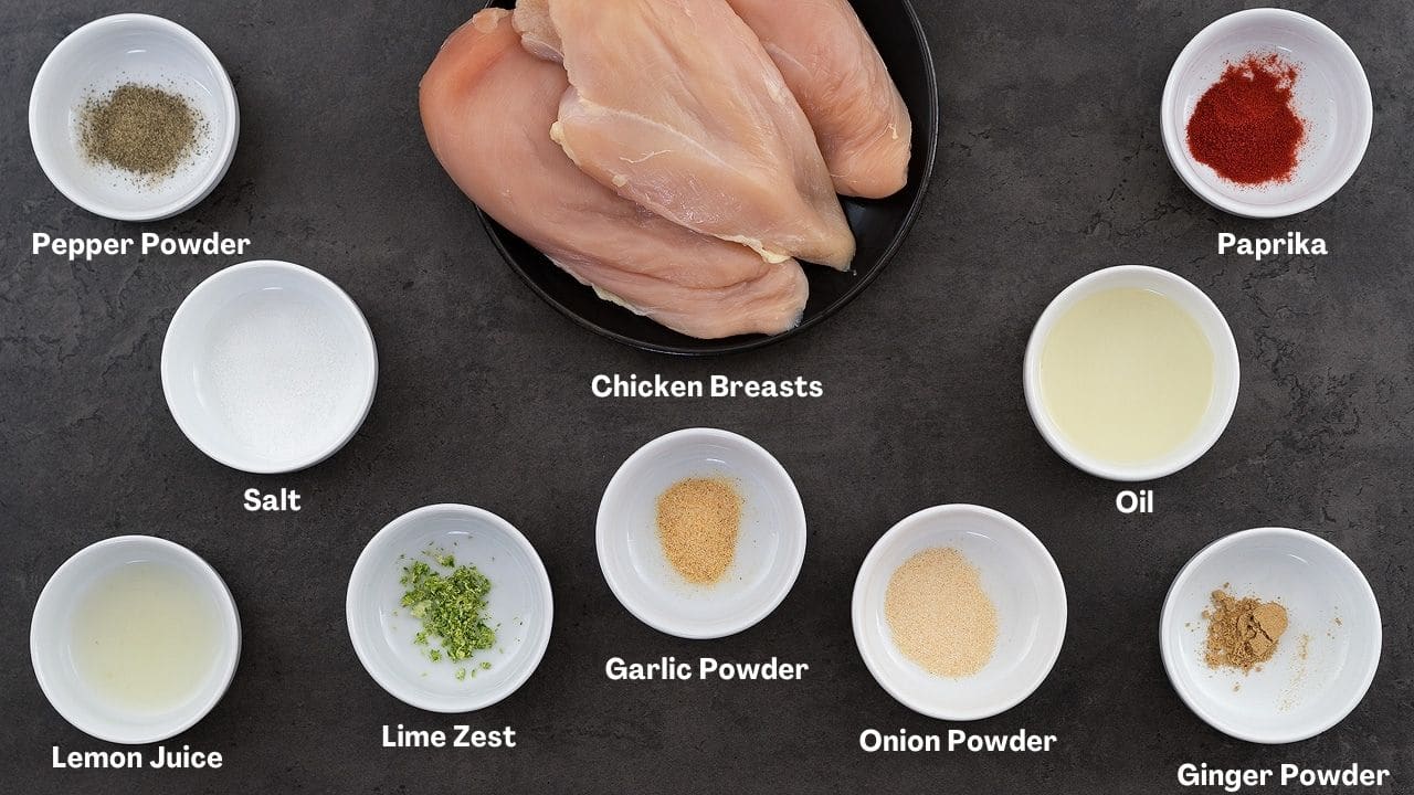 Air fryer chicken breast ingredients placed on a grey table