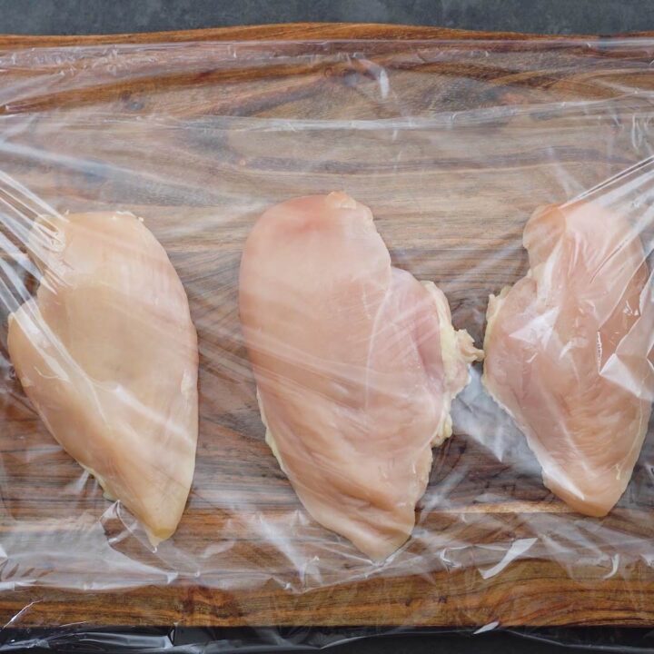 Chicken breast covered with a plastic wrap