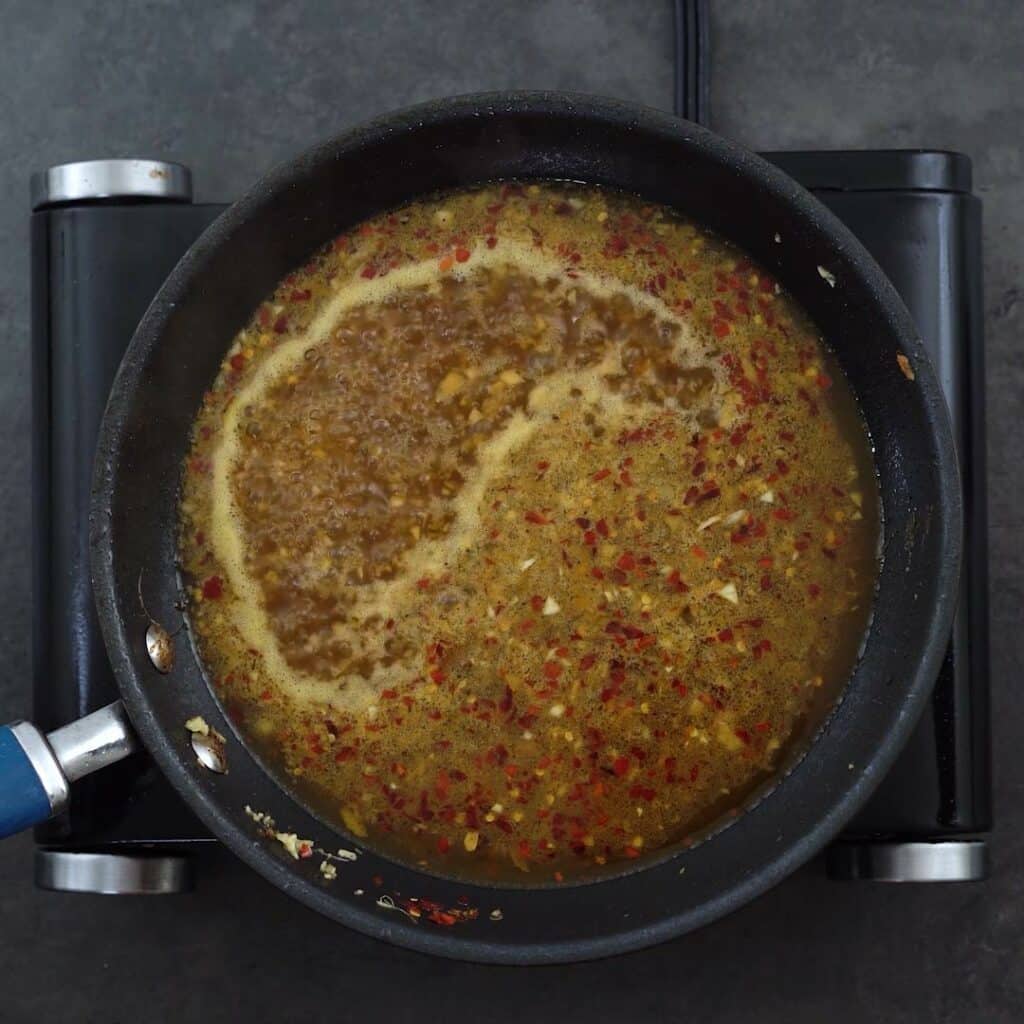 Orange sauce mixture boiling in a pan