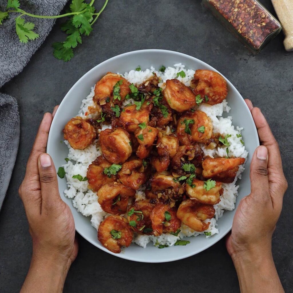 Serving Honey Garlic Shrimp over rice in a bowl