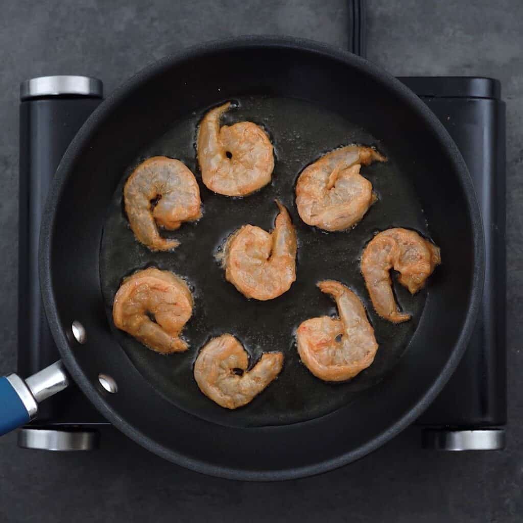 Shrimp is frying in a pan