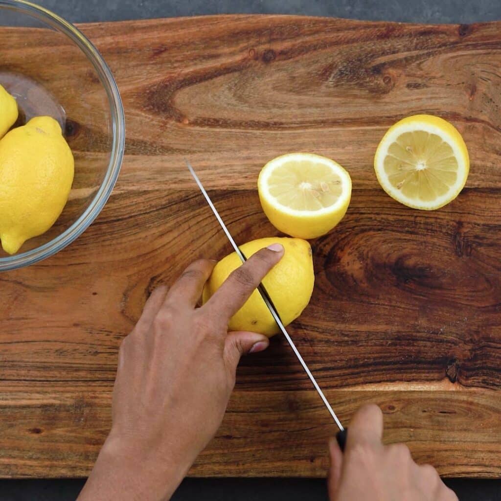Cutting lemons in half.