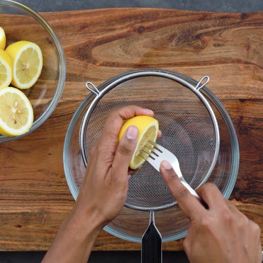 Squeezing juice from lemon.