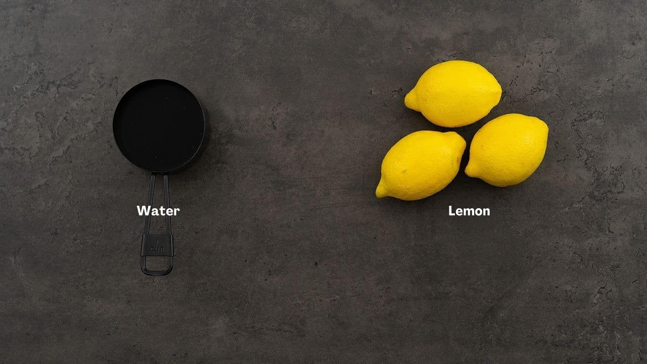 Lemon water ingredients on a grey table.