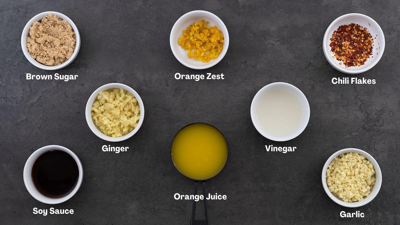 Orange chicken ingredients placed on a grey table