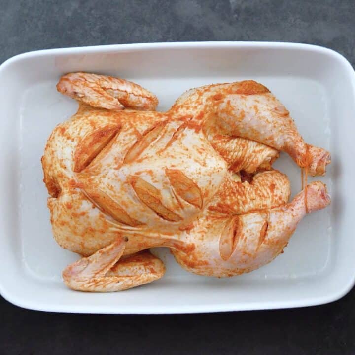 Whole chicken is roasting in the oven