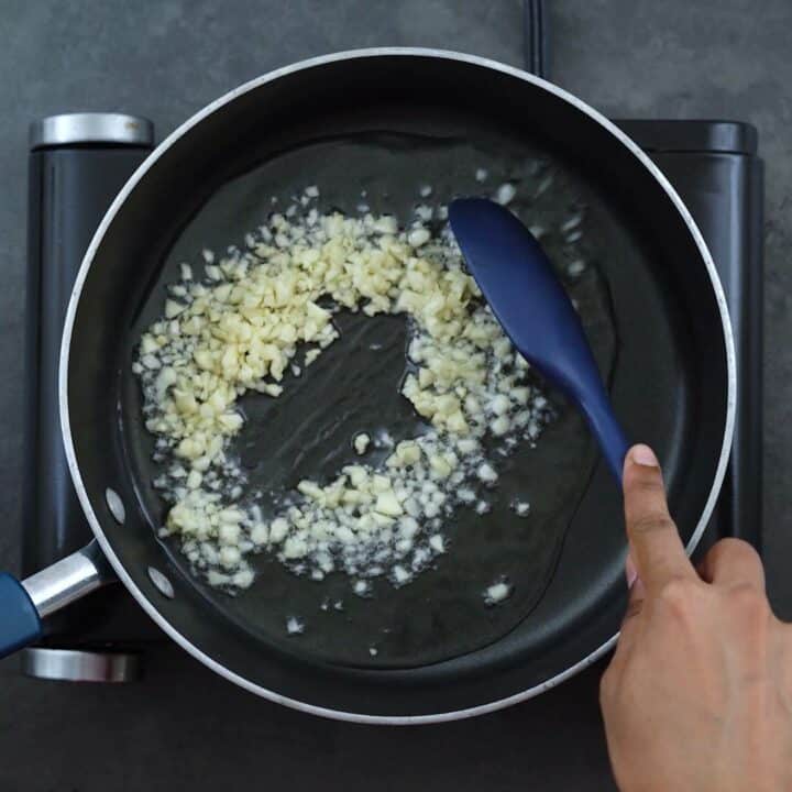 Sautéing garlic in a pan