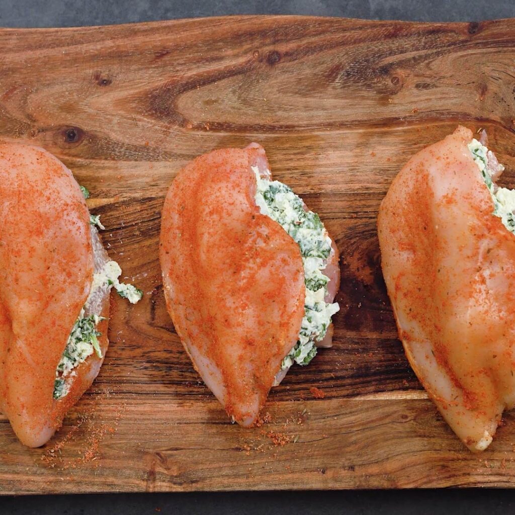 Spinach stuffed chicken breast on a cutting board