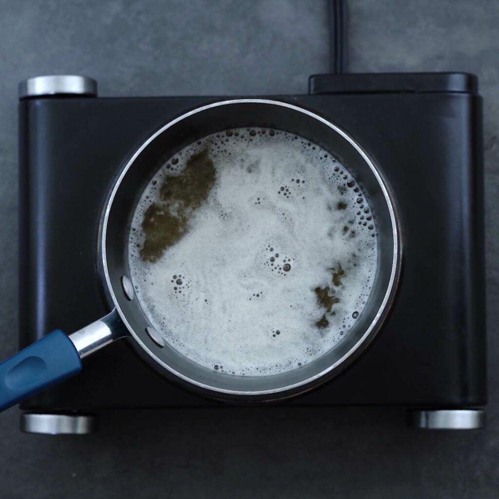 Sugar water boiling in a saucepan.