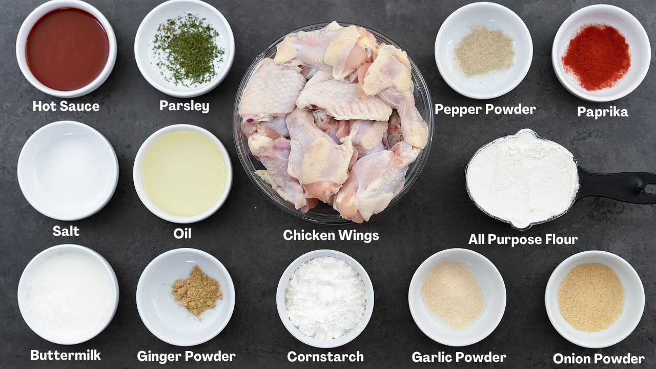 Fried Chicken wings recipe ingredients in cups on a grey table.