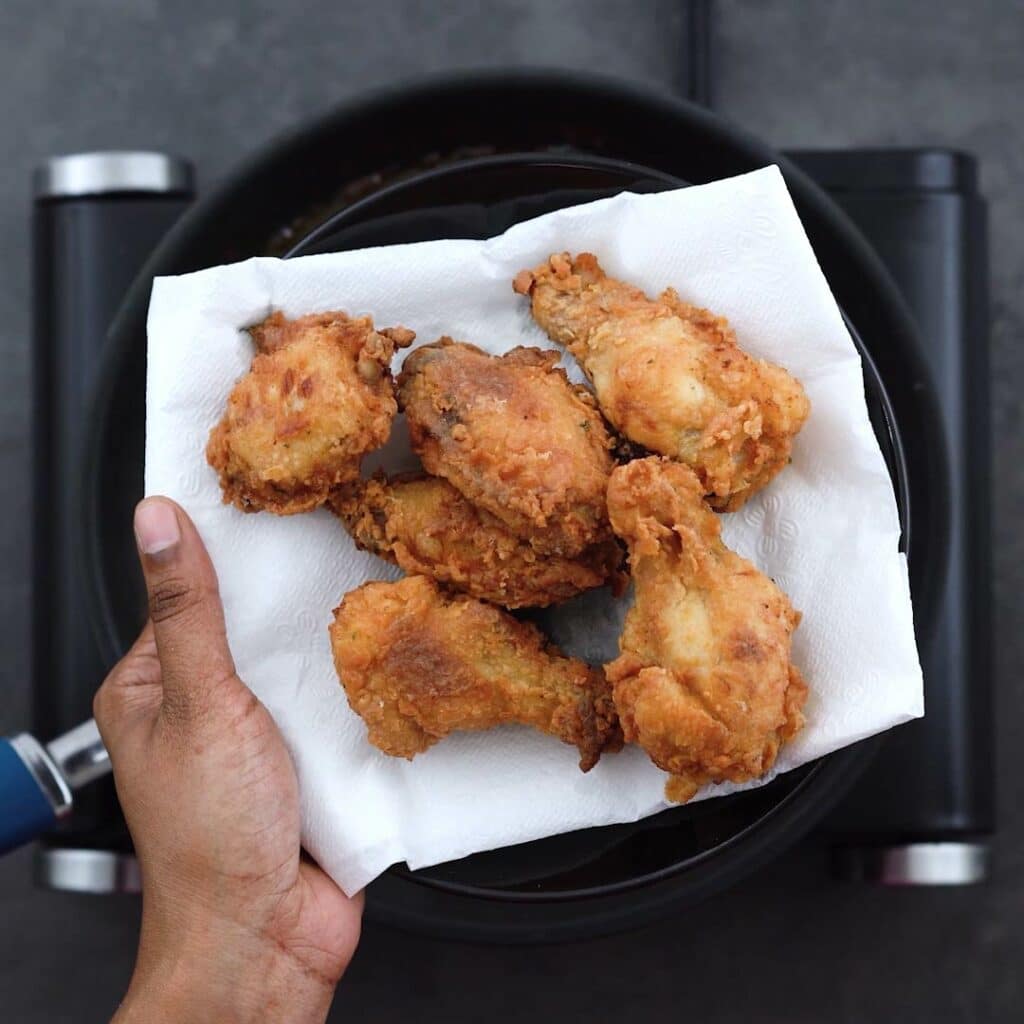 Crispy Fried Chicken Wing on a plate with tissue paper.