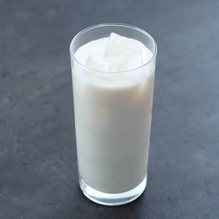 Horchata served with ice cubes in a serving glass.