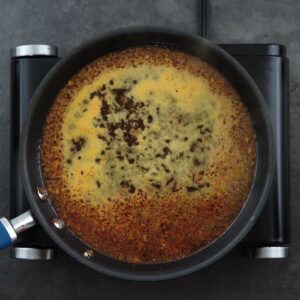 Orange Sauce mixture boiling in a pan.