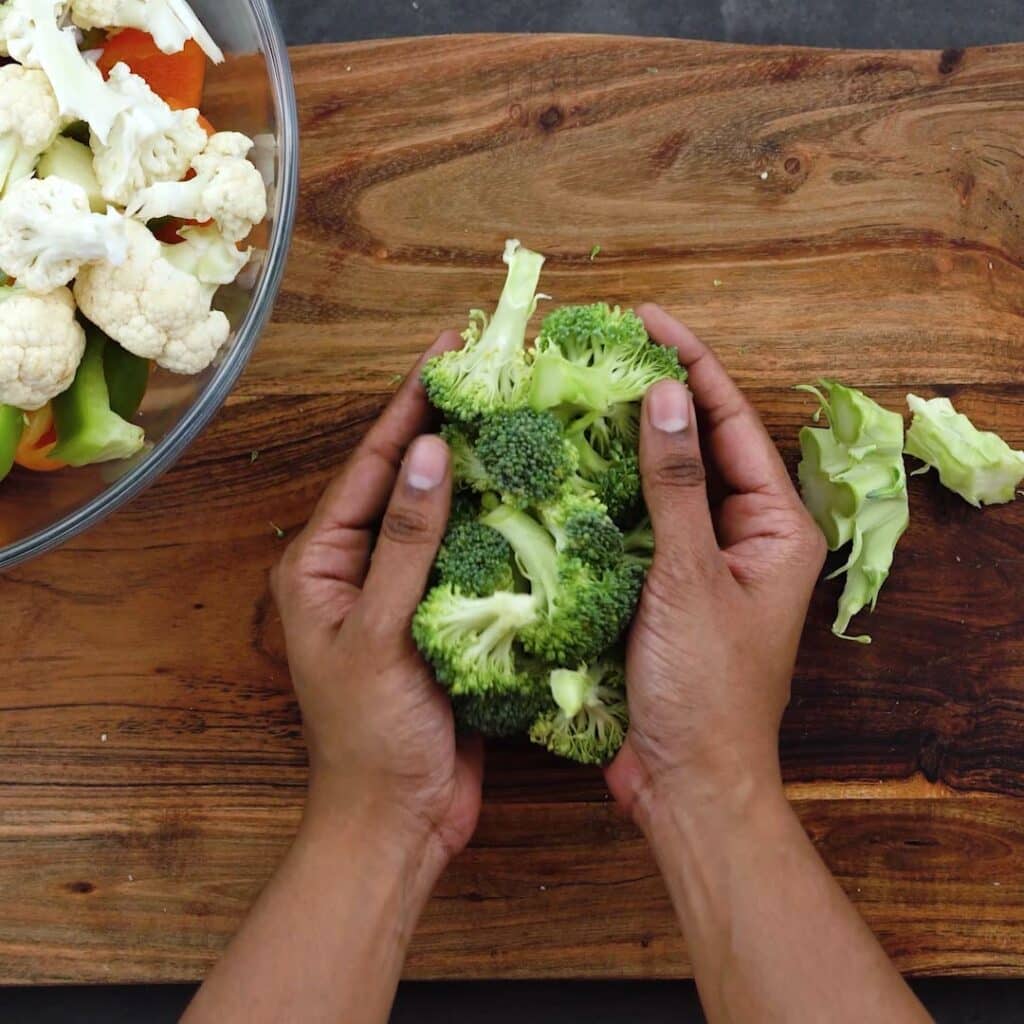 Transferring chopped broccoli florets into a bowl
