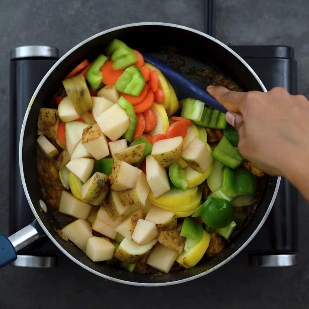 Sauteing the veggies in yellow curry paste