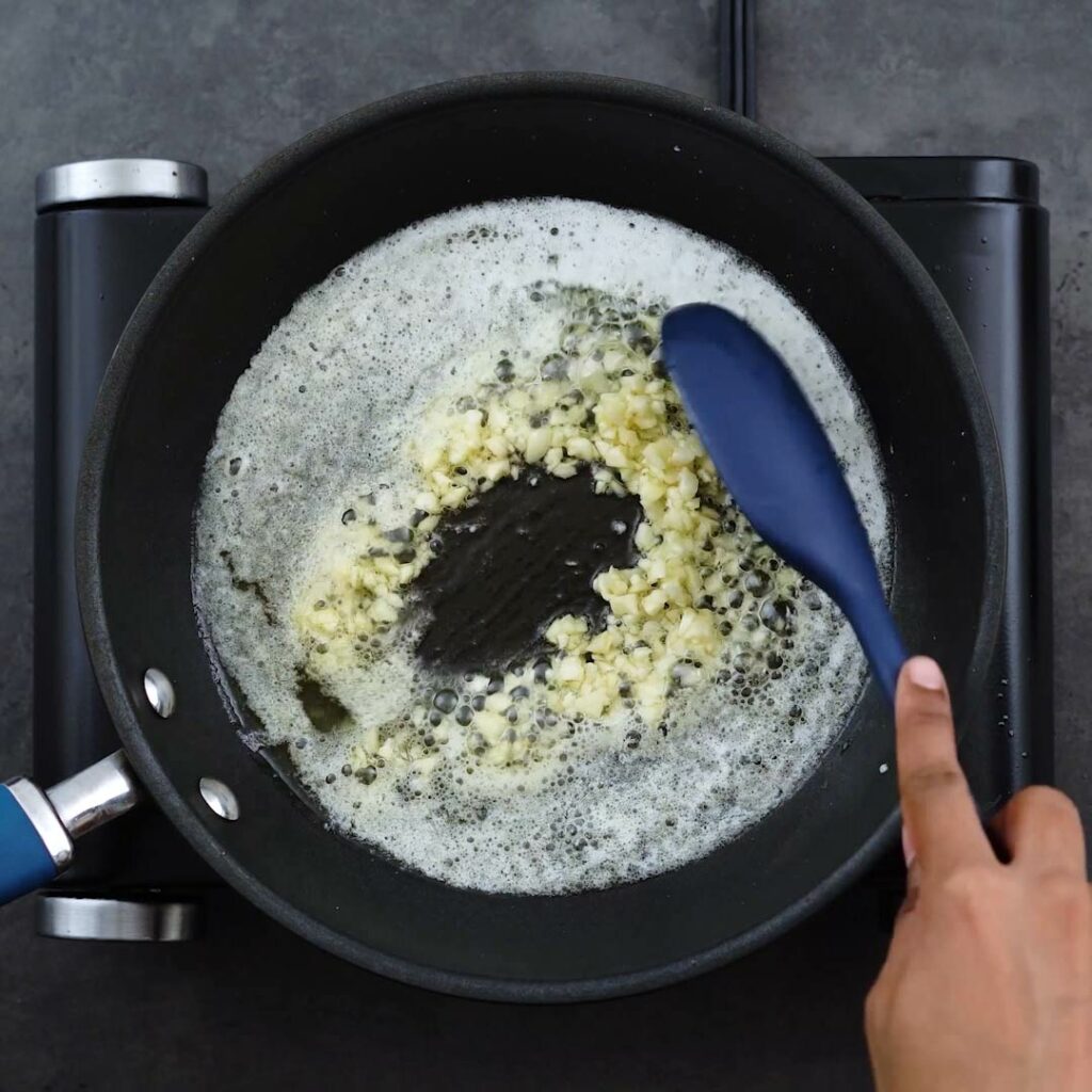 Sauteing the garlic in a frying pan.