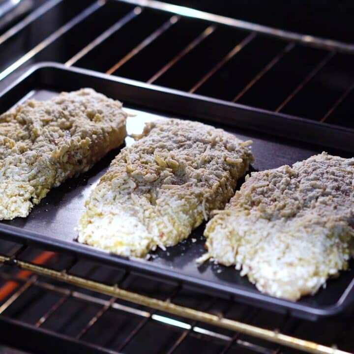 Breaded chicken breast placed inside the oven.