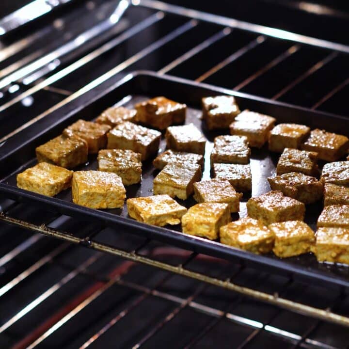 Tofu placed inside the oven on a baking tray.