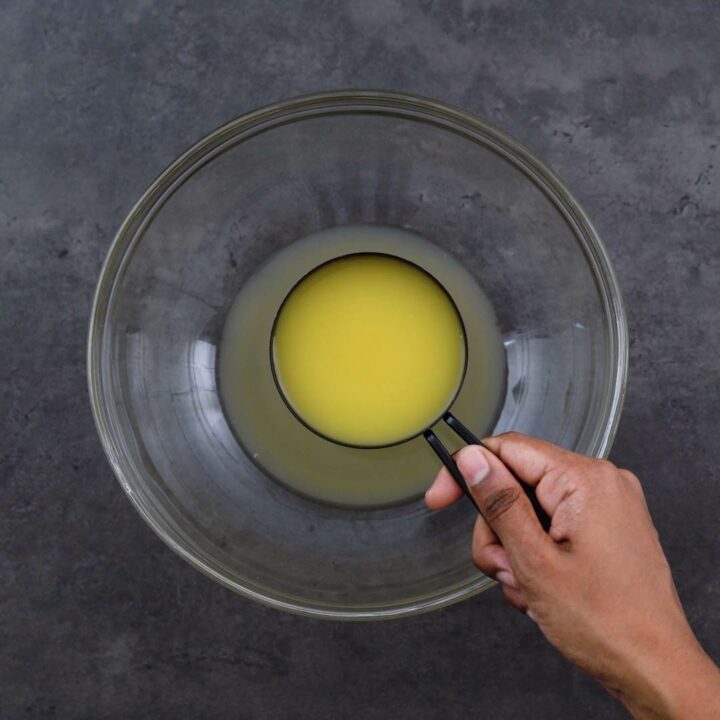 Adding Orange Juice into a bowl.