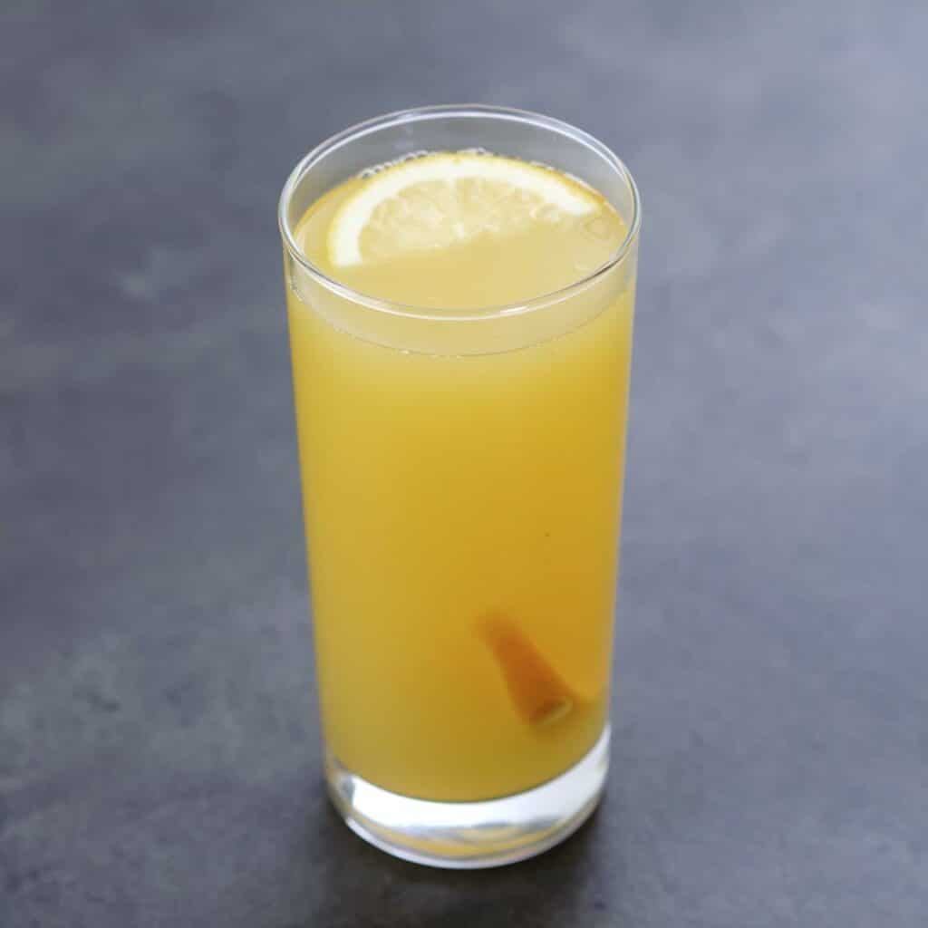 Homemade Electrolyte Drink in a serving glass with lemon and orange slices.