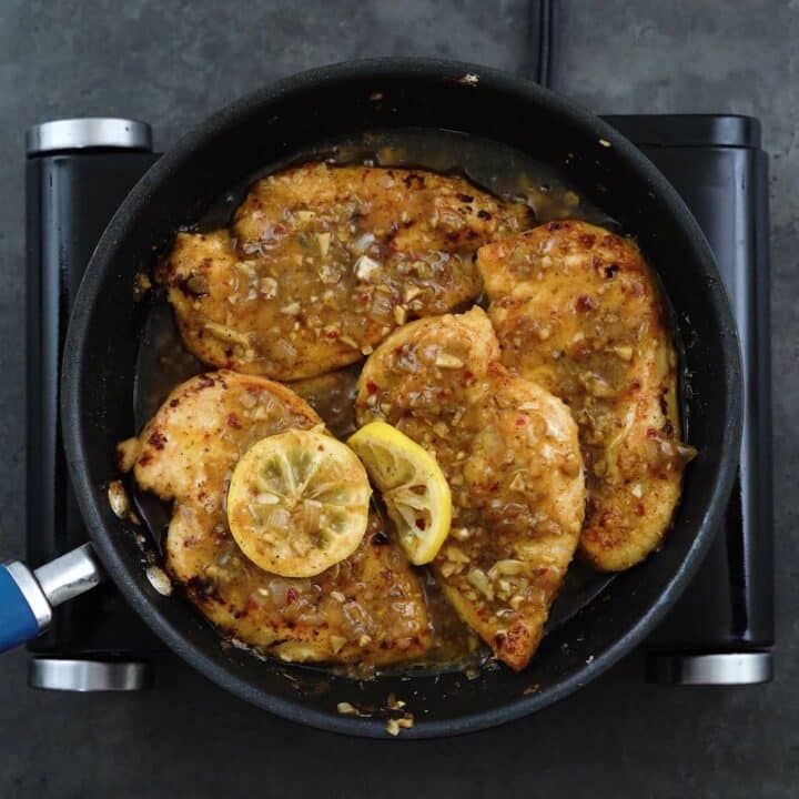 Lemon Chicken simmering in a pan.