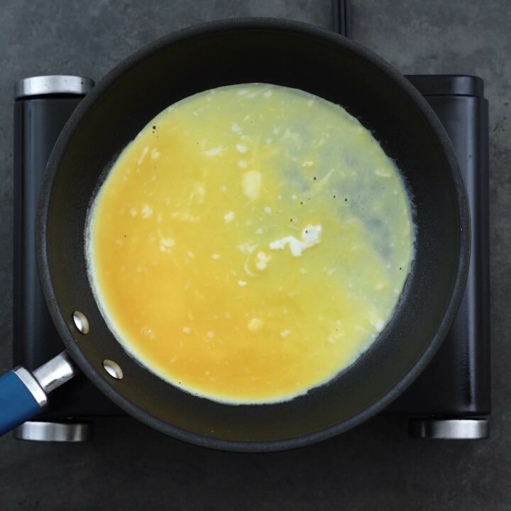Thin layer of egg cooking in the pan.