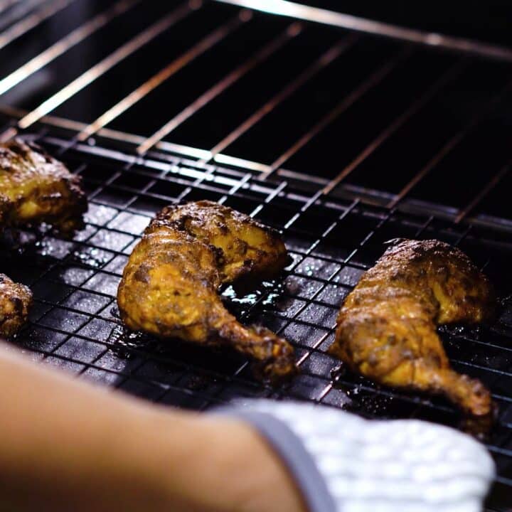 Removing the Tandoori Chicken from the oven.