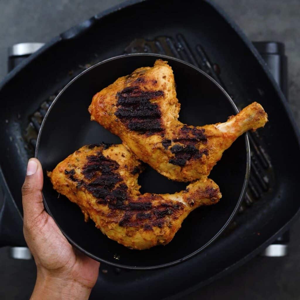 Perfectly grilled Chicken tandoori on a plate.