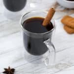 Cafe de Olla in glass coffee cups with few ingredients and biscuits around.