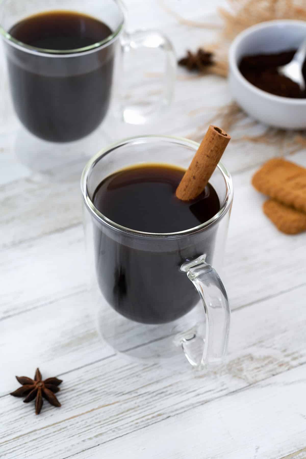 Cafe de Olla in glass coffee cups with few ingredients and biscuits around.