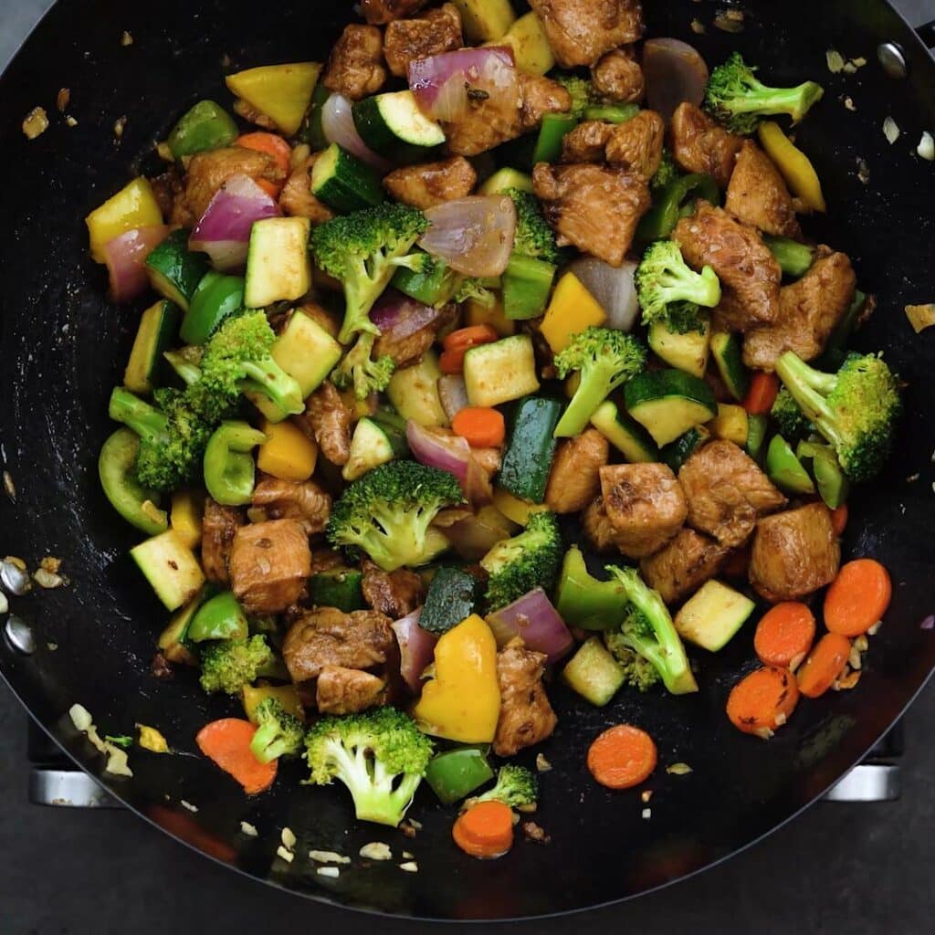 Stir Fried vegetables and chicken in a wok.