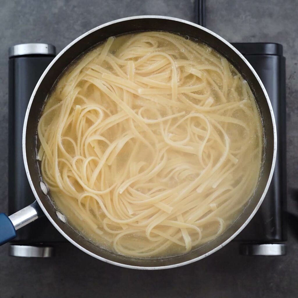 Fettuccine Pasta cooking in water.