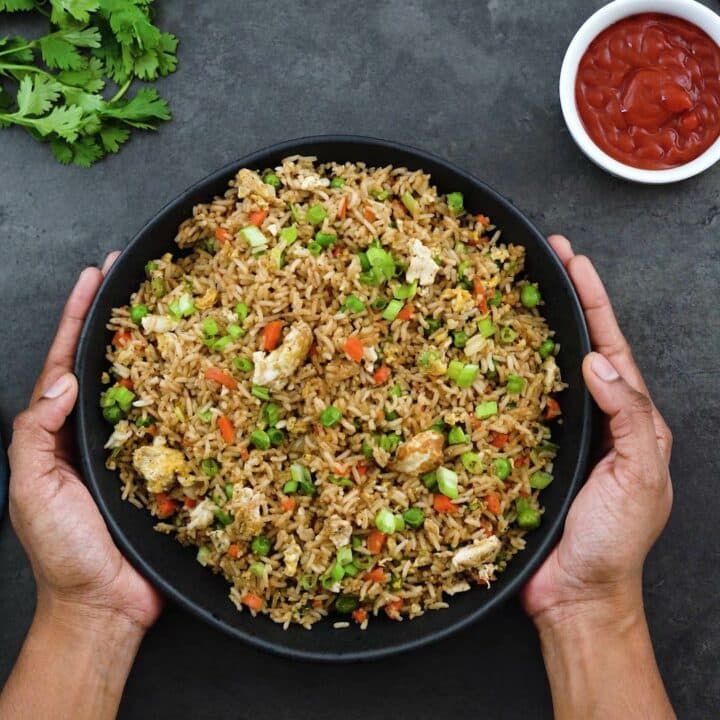 Fried Rice serving in a bowl with ketchup alongside.