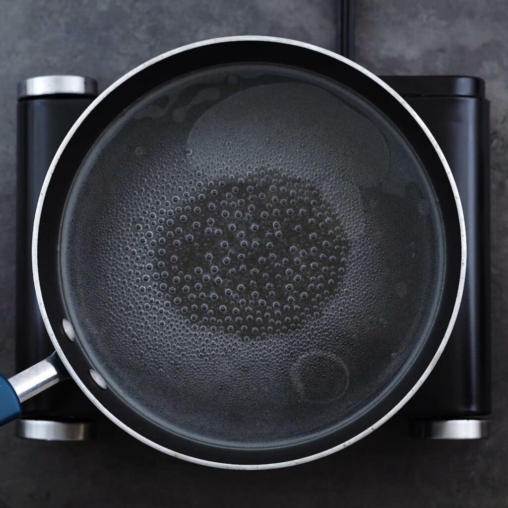 Water is boiling in a wide bottom pan.
