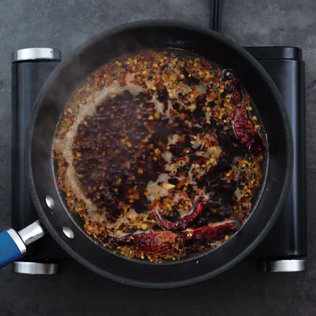 Stir fry sauce mixture boiling in a pan.