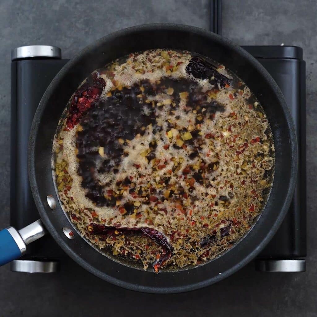 Sauce mixture boiling in a frying pan.