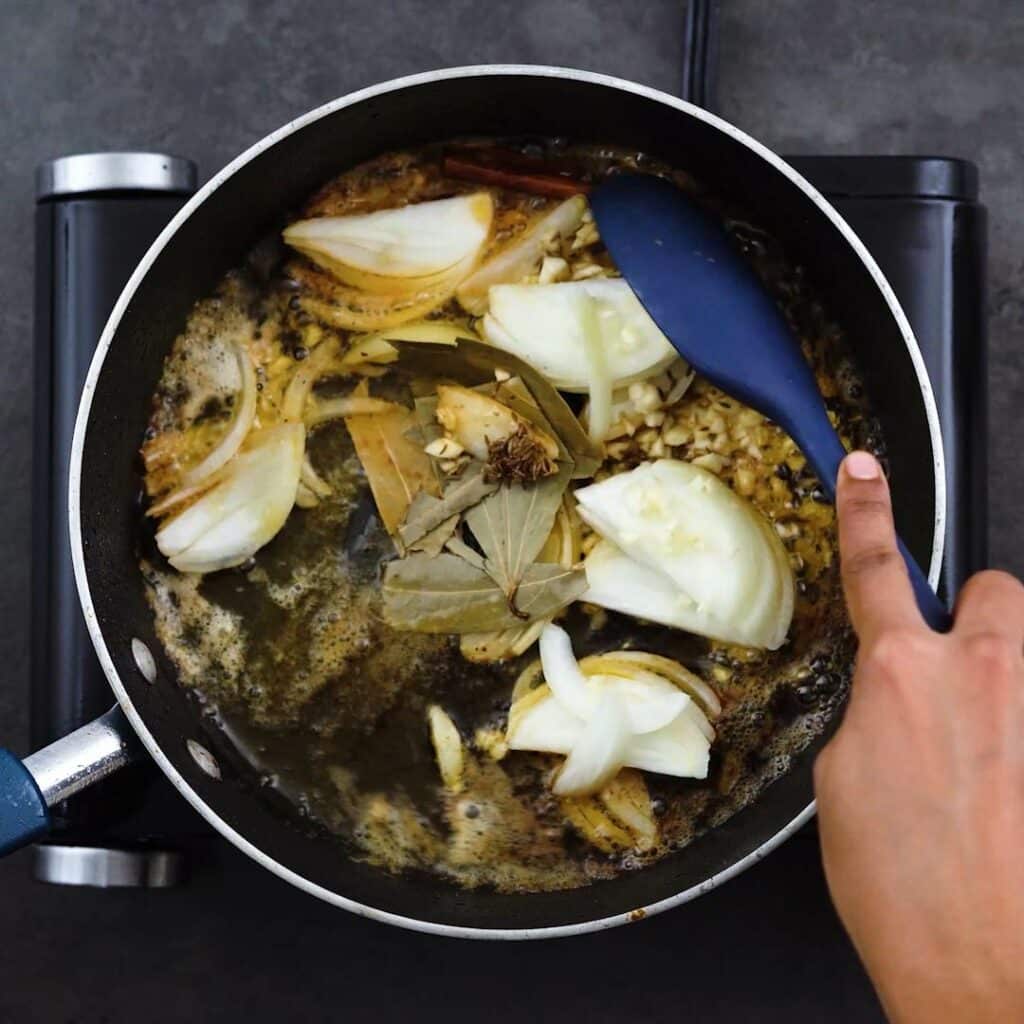 Sauteing the aromatics in a pot.