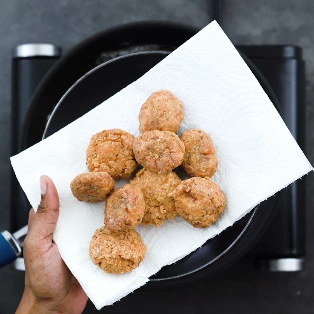 Fried Chicken Nuggets on a black plate with tissue paper.