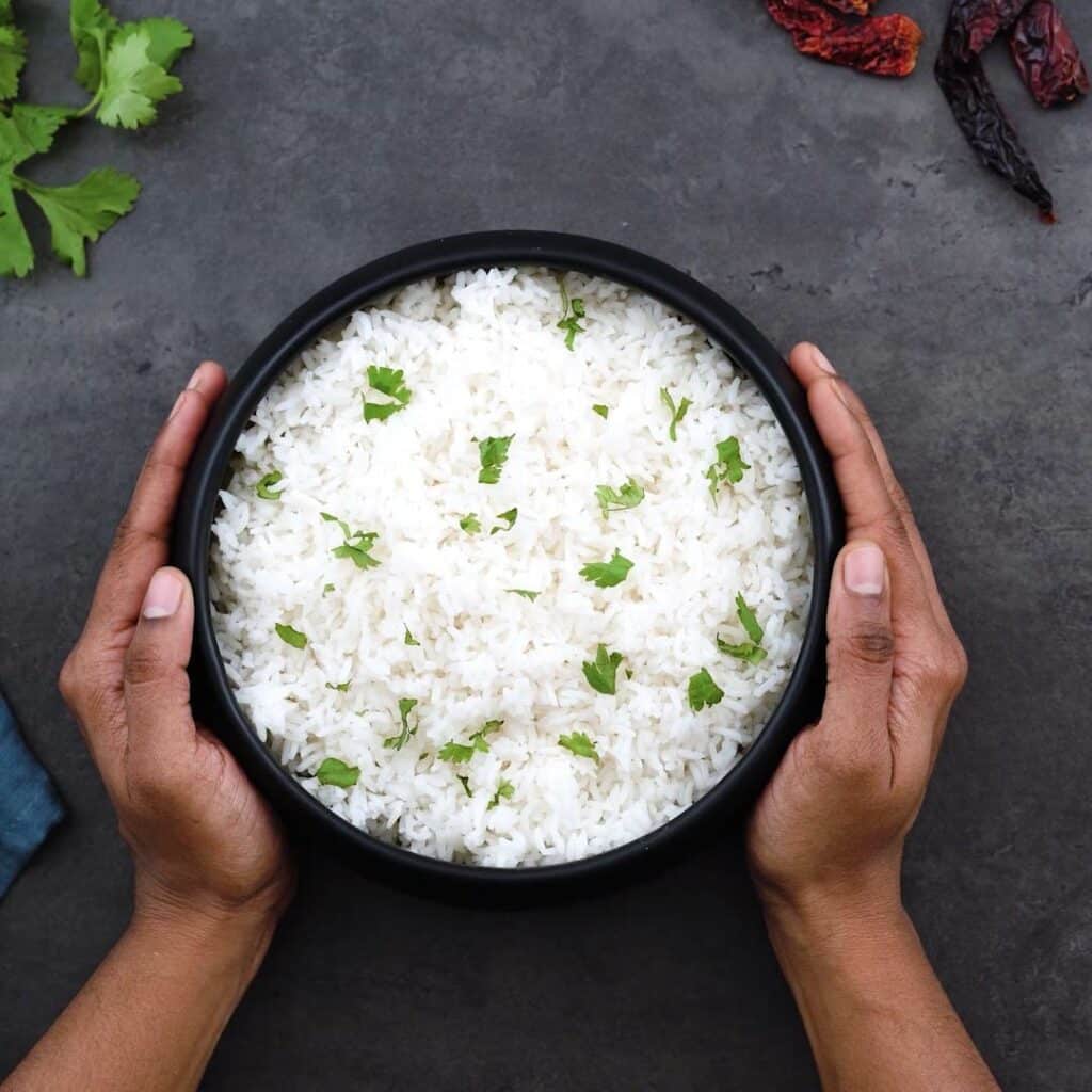 Serving White Rice in a black bowl.