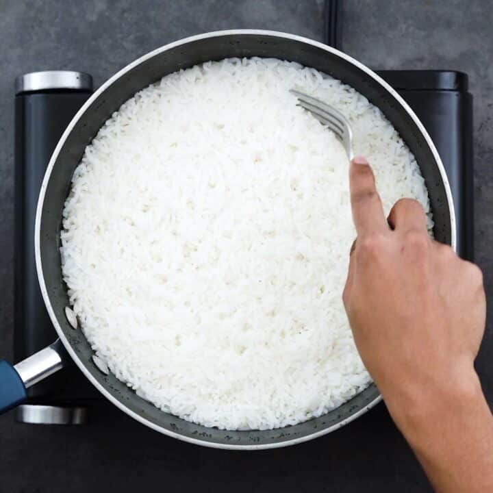 Fluffing the Jasmine rice with fork.