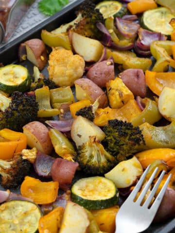 A close-up shot of roasted vegetables arranged in a baking tray.
