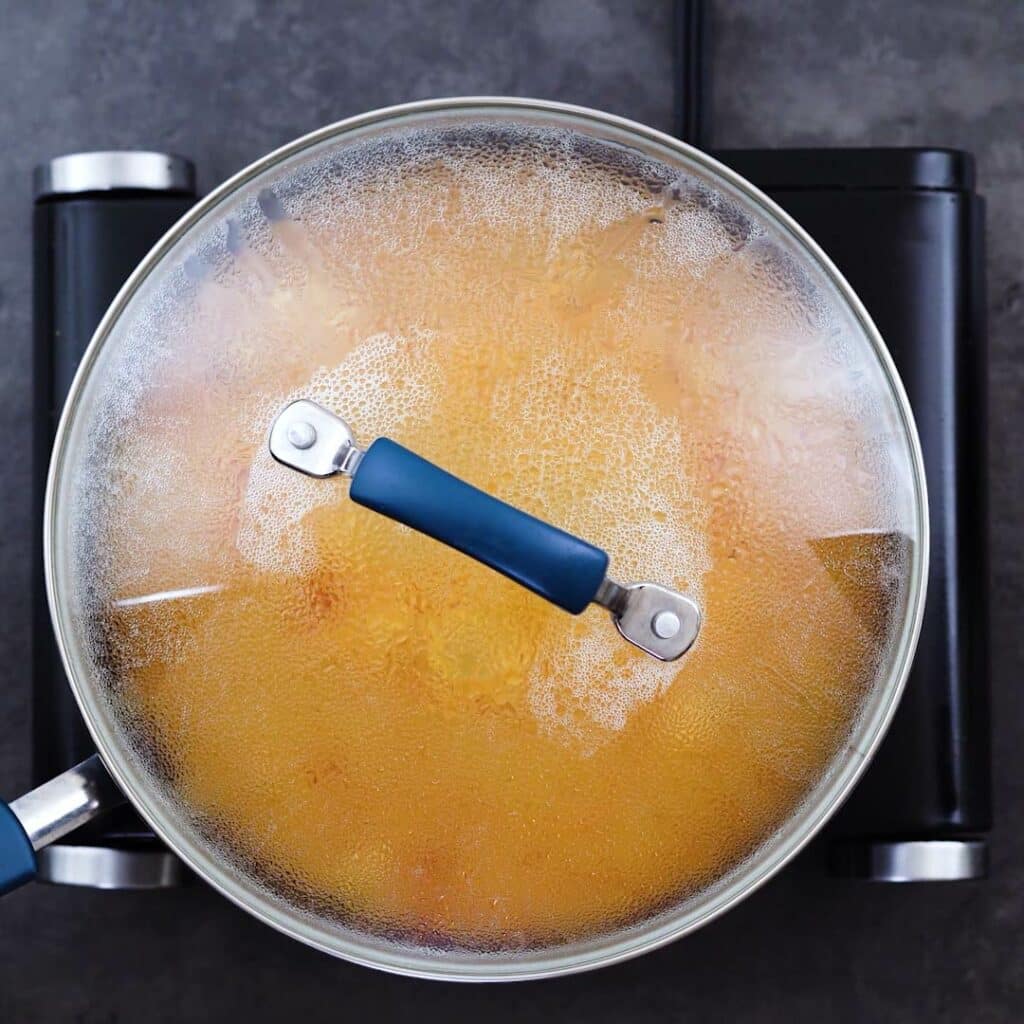 Chicken is cooking with lid closed.