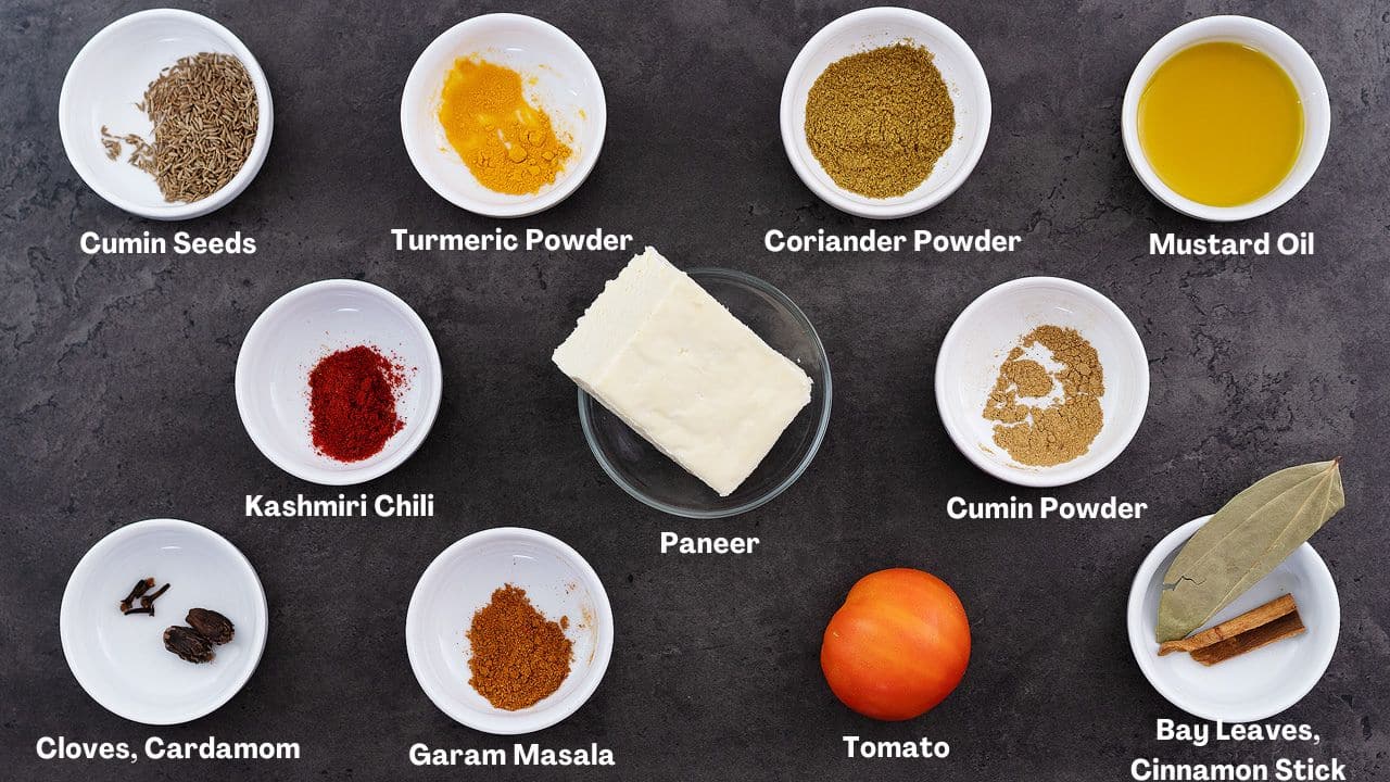 A grey table featuring the ingredients needed for a recipe of saag paneer.