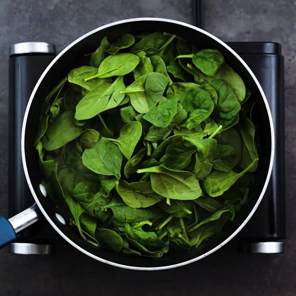 Spinach and fenugreek leaves blanching in water.