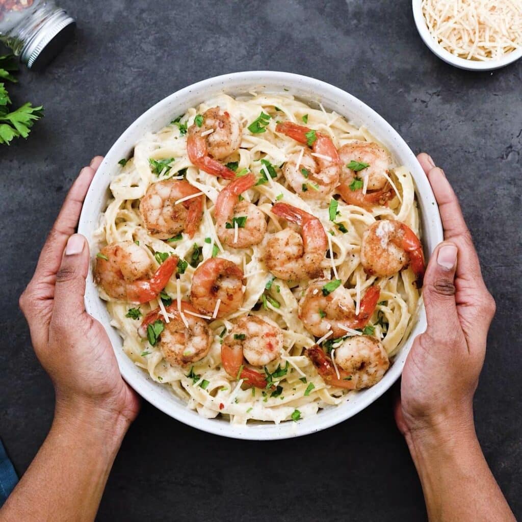 Serving Shrimp Alfredo pasta in a serving bowl.